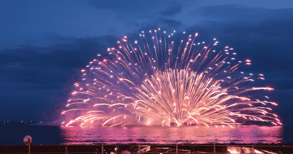 Spectacular fireworks forming a giant fan shape right on the water in Kamakura.